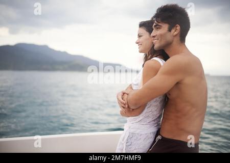 Treating ourselves to a romantic getaway. an intimate young couple enjoying a boat ride on the lake. Stock Photo