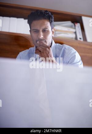 Hes ready for whatever the business world throws at him. a handsome young businessman in his office. Stock Photo