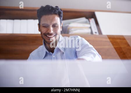Hes ready for whatever the business world throws at him. a handsome young businessman in his office. Stock Photo
