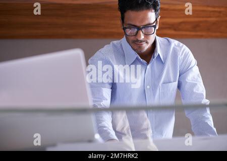Hes ready for whatever the business world throws at him. a handsome young businessman in his office. Stock Photo