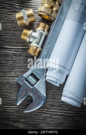 Adjustable wrench plumbing pipe fittings rolled blueprints Stock Photo ...