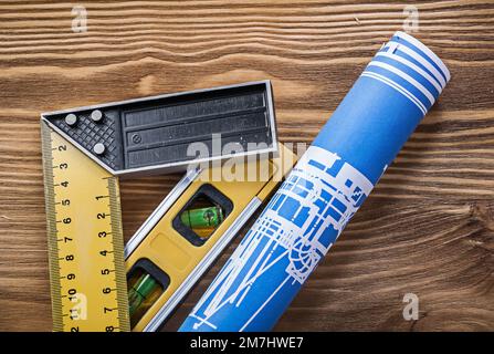 Blue construction drawing level square ruler on wooden board. Stock Photo