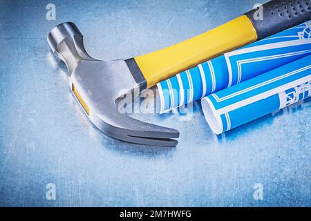 Blue construction drawings claw hammer on metallic background copy ...