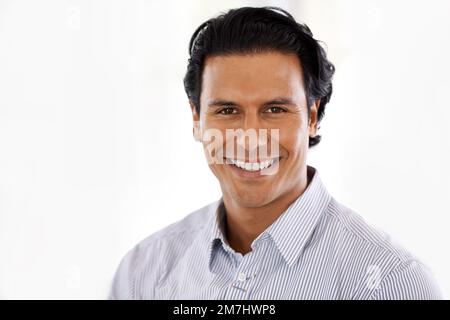 Young and confident. Studio portrait of a handsome young man isolated on white. Stock Photo