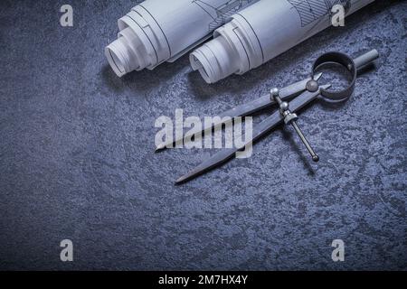 Blueprints pair of compasses on black background construction concept. Stock Photo