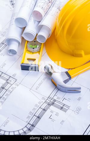 claw hammer construction level helmet rolled blueprints Stock Photo