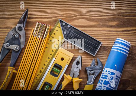Composition of building tools on vintage wooden board top view. Stock Photo