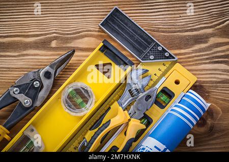 Composition of construction tools on vintage wooden board top view. Stock Photo