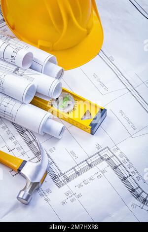 composition of rolled blueprints claw hammer construction level helmet Stock Photo