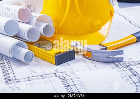 construction tools rolled blueprints level claw hammer helmet Stock Photo