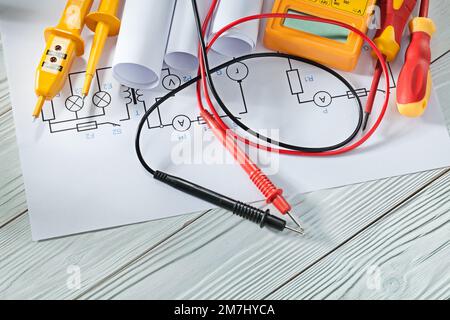 electric tester and multitester insulated screwdrivers blueprints on white vintage wood Stock Photo