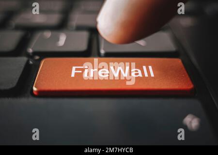 Closed up finger on black keyboard with word FIREWALL Stock Photo