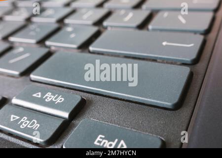 button on the black keyboard of modern ultrabook close up. caption on the button Stock Photo