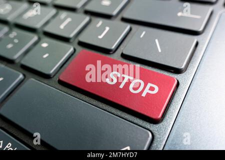 Computer notebook keyboard with Stop key - technology background. , Red button. Stock Photo