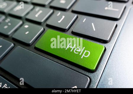 Keyboard - with a big HELP. Picture of green button on the keyboard with word of HELP Stock Photo