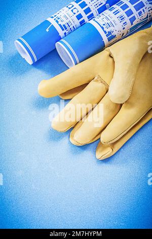 Engineering plans leather safety gloves on fluted metal sheet building ...