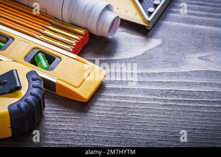 Instruments of measurement blueprints and construction level on vintage wood board maintenance concept. Stock Photo