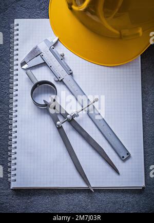 Notebook building helmet drawing compass vernier caliper construction concept. Stock Photo