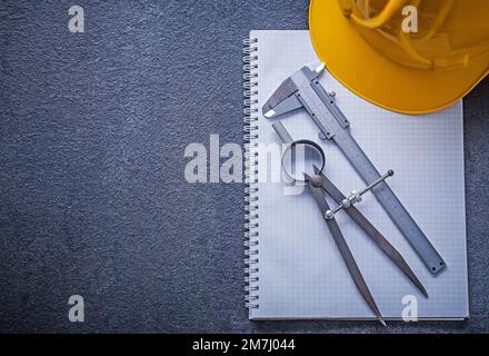 Notebook building helmet drawing compass slide caliper construction concept. Stock Photo