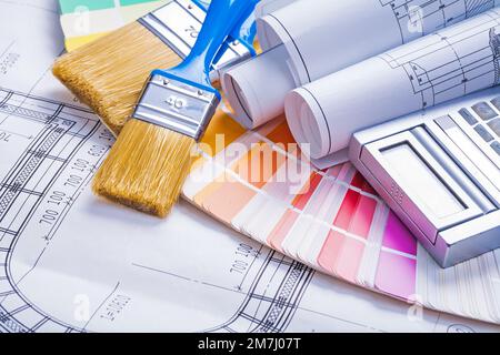 paintbrushes rolled blueprints calculator on color palette Stock Photo