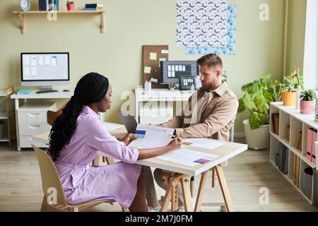 Portrait of two UX designers working together in minimal office setting, copy space Stock Photo