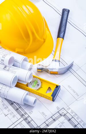 rolled up blueprints helmet level claw hammer construction concept Stock Photo