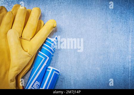 Safety gloves blue rolled blueprints claw hammer Stock Photo - Alamy
