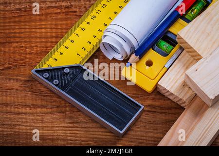 Try square pencil blueprints wooden studs construction level on vintage wood board maintenance concept. Stock Photo