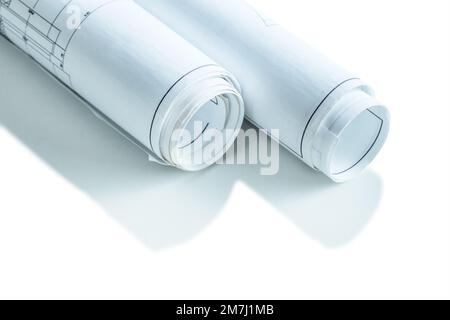 two white rolled up blueprints isolated very close  up Stock Photo