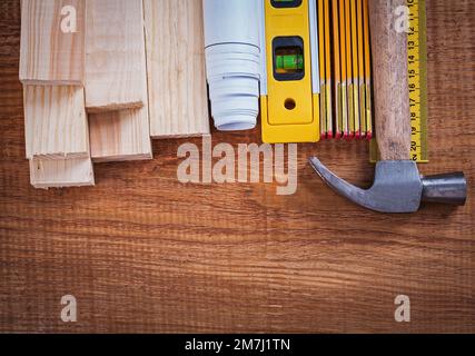 Wooden bricks and meter blueprints ruler hammer construction level on vintage wood board building and architecture concept. Stock Photo
