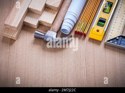 Wooden studs and meter ruler hammer blueprints construction level on ...