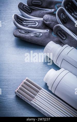 rolled blueprints wooden meter and protective working gloves Stock ...