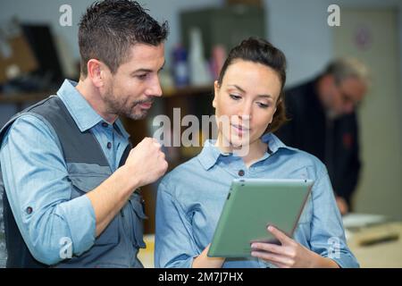portrait of workers looking at tablet Stock Photo
