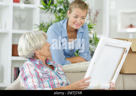 mother with daughter looking at photo frame Stock Photo