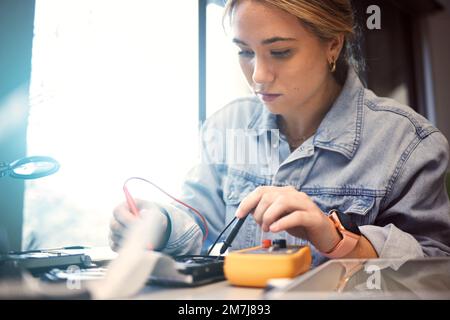Engineer, student and woman repair electronics for science project. Learning, education and female technician with technology testing microchip Stock Photo