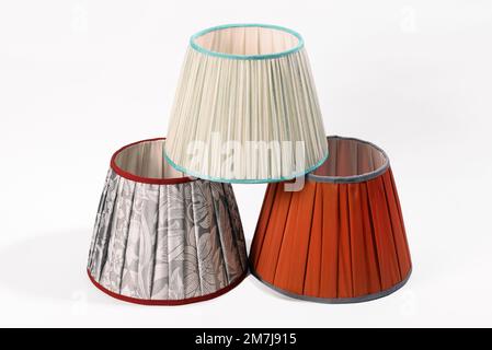 From above of orange beige and with ornament lampshades arranged in form of pyramid isolated on white background Stock Photo