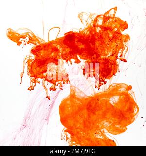 Food colouring swirling through water creating abstract patterns Stock Photo