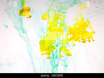 Food colouring swirling through water creating abstract patterns Stock Photo