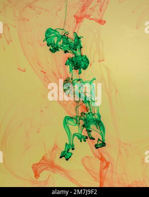 Food colouring swirling through water creating abstract patterns Stock Photo