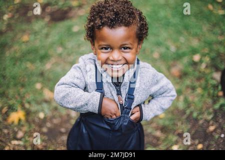 Portrait of happy boy standing in park Stock Photo