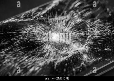 Shattered glass touch screen mobile phone. Broken smartphone black texture. Macro shot Stock Photo