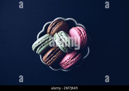 Macaroons on dark background, colorful french cookies macaroons Stock Photo