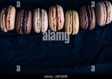 Macaroons on dark background, pastel french cookies macaroons Stock Photo