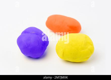 Blue, red and yellow moulds of plasticine in a white surface Stock Photo