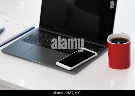 Shot of a laptop and other various items on a work desk in a modern office Stock Photo