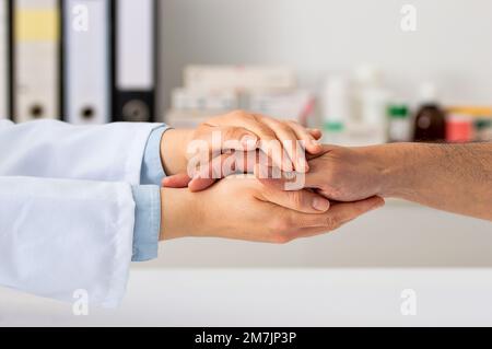Closeup shot of an unrecognizable doctor holding a patient's hand in comfort Stock Photo