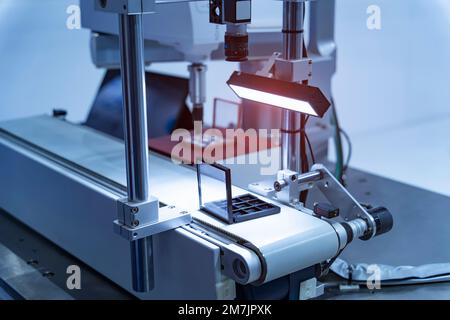 robotic arm manipulator moving on conveyor belt. Manufacturing, engineering, industrial, ai, automated technology concept Stock Photo