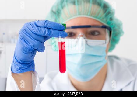 Shot of a female scientist conducting medical research in a laboratory with focus on the test tube Stock Photo