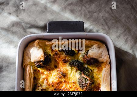Sliced traditional french open quiche pie with cheese and broccoli Stock Photo