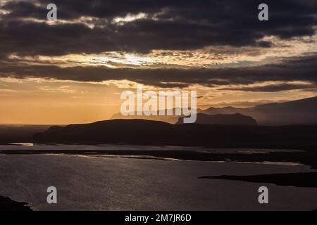Beautiful landscape with lake and mountain range. Light reflections in the water. Tough nature in Iceland at sunset. Stock Photo
